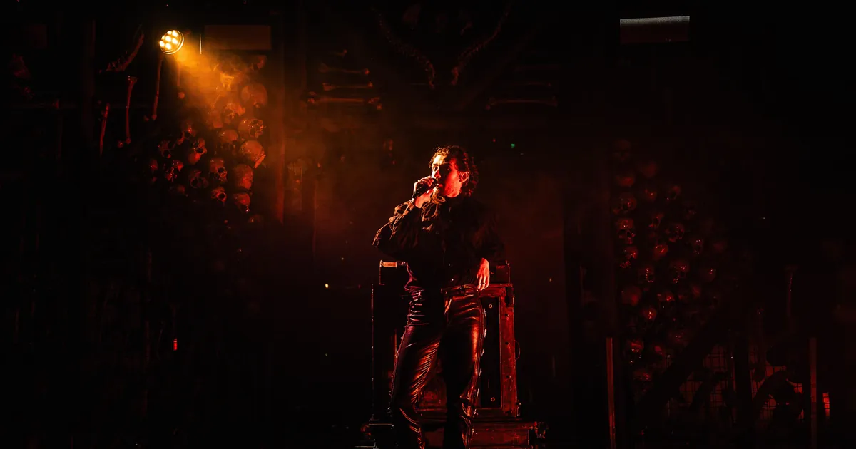 A singer in an amber spotlight on a dark gothic stage at Dracula's in Broadbeach